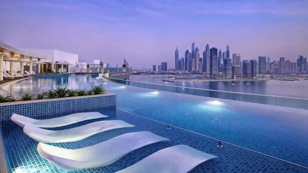 Ein moderner Poolbereich mit mehreren Ebenen und Blick auf die Stadtlandschaft.