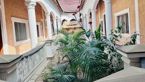A courtyard with a central water feature, surrounded by columns and plants. - Villa Jahawi (Diani Beach)