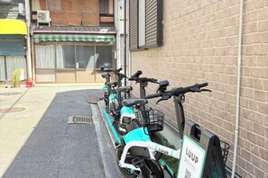 A row of electric scooters parked against a brick wall, with a QR code and the word 'LUUP' visible. - 4 bedrooms, 2 bathrooms, 2 toilets, spacious house with convenient transportation (Kyoto)