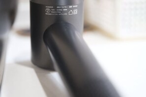 A close-up of a black object with text and symbols, possibly a piece of equipment or furniture. - sakuranoyado2 (Tokyo)
