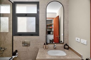 A modern bathroom with a large mirror, a sink, and a shower. - Sodic Villette New Cairo by BirdNest (New Cairo)