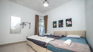 A bedroom with two beds, a mirror, and three wall-mounted pictures. - d'Lux 6BR16-25px Pool/BBQ/NetFlx/HotPot/KTV/Mahjong (Bandar Penawar)