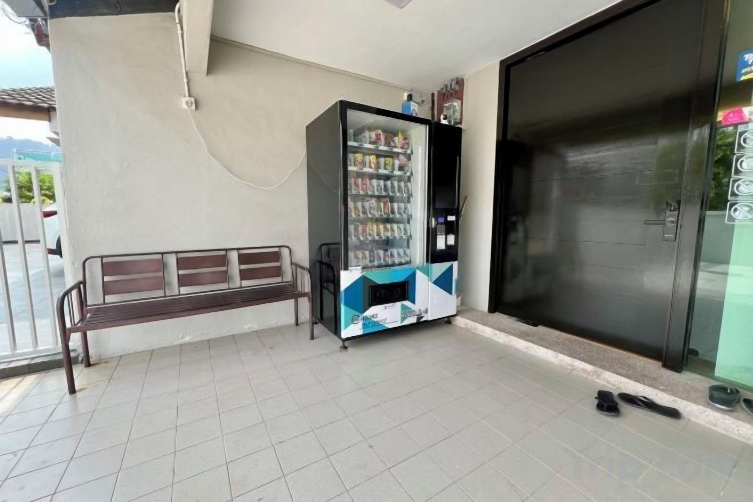 A vending machine, a bench, and a closed door.
