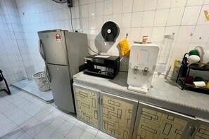 A kitchen with a refrigerator, microwave, and coffee maker. - 8 mins driving to T.C Beach @ Holiday Guest House (Kuala Kuantan)