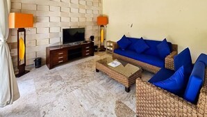 A living room with a TV, wicker sofa, and two lamps. - The Lavana Villa Bukit Jimbaran (2 Bedroom Villa with Private Pool - Minimum Stay 3 Nights) (Bali)