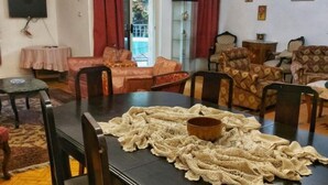A living room with a dark wooden table, a knitted table runner, and patterned armchairs. - Jessy Residential Apartment (Cairo)