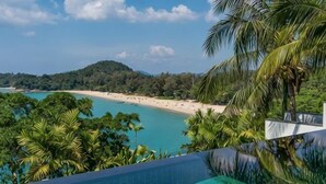 A pool with a view of a beach and palm trees. - Laemsingh Villa 3 (Phuket)