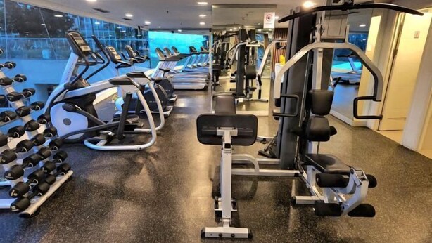 A gym with treadmills, dumbbells, and weight machines. - Trivium Terrace Apartment Lippo Cikarang (Min Stay 3 Nights) (South Cikarang)