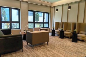 A hotel lobby with seating areas, large windows, and a carpeted floor. - TRX AGILE Bukit Bintang Superior 8 Pax Family Suites (Kuala Lumpur)