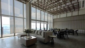A spacious, modern interior with large windows, a sofa, coffee table, and a dining area. - TRX AGILE Bukit Bintang Superior 8 Pax Family Suites (Kuala Lumpur)