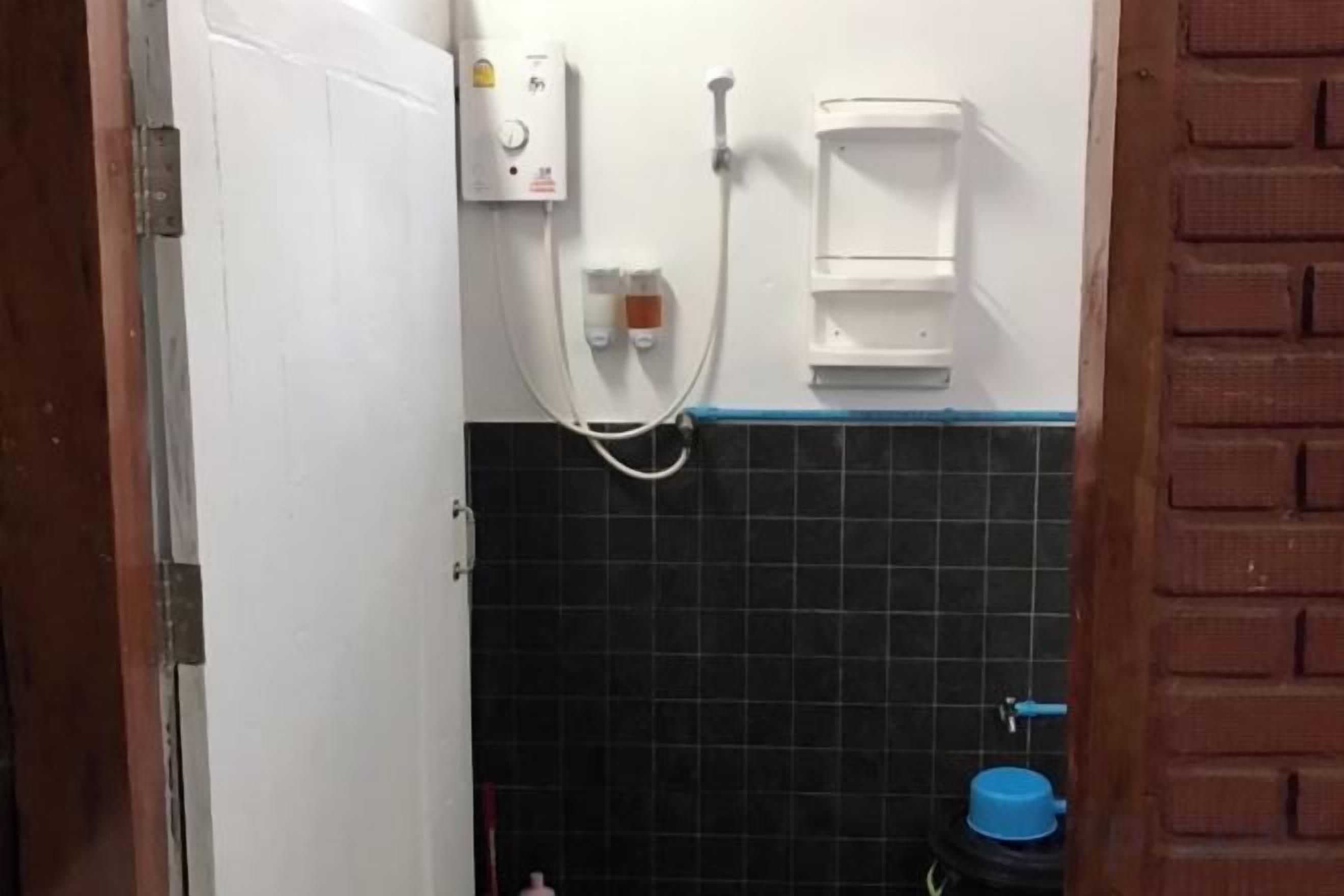 A bathroom with a shower, a toilet, and a sink.