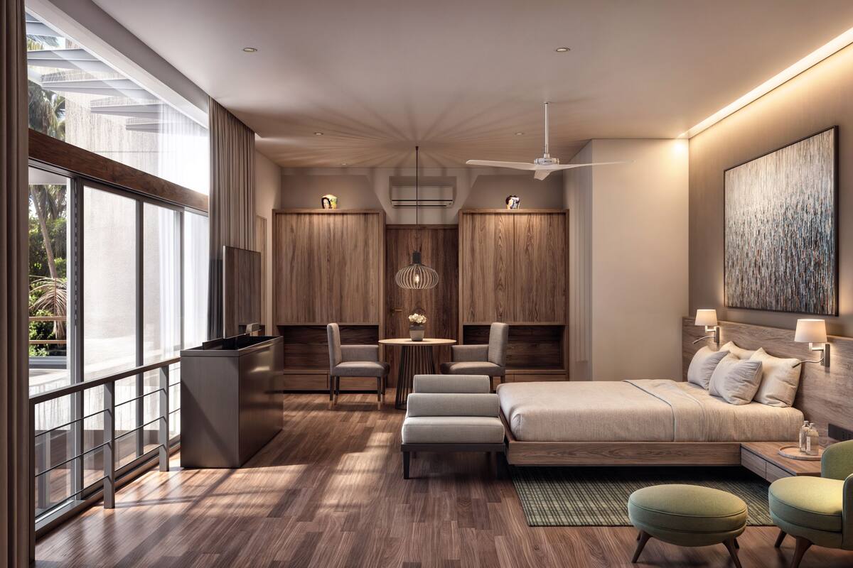 Una habitación de hotel moderna con una cama grande, un escritorio, dos sillas y un balcón.