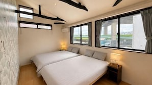 A bedroom with two beds, large windows, a wooden ceiling, and a view of the outdoors. - KandoStay Asakusa East Terrace (Tokyo)