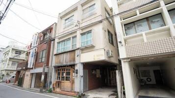 Edifício com vários andares, com espaço comercial no térreo e apartamentos nos andares superiores.