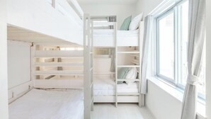 A room with bunk beds, a window with curtains, and a white interior. - Downtown Mix (Tokyo)