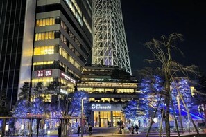 A modern building with illuminated signage for 'UNIQLO' and 'Solamachi'. - YMK Oshiage 7B (Tokyo)