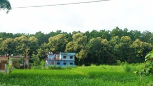 A two-story building with a sign indicating it is a hotel. - Hoztel Jollygrrant Doon (Dehradun)