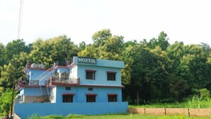 A two-story building with a sign reading "HOZTEL" on the top. - Hoztel Jollygrrant Doon (Dehradun)