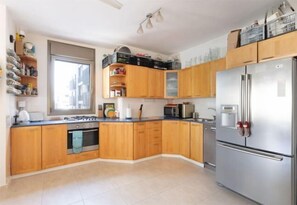 Iron/ironing board - Cozy 3BR Apt w Big Windows 5 Min Walk From Beach (Tel Aviv)