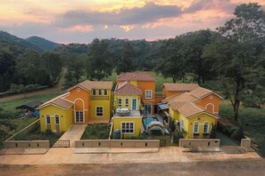 A multi-story house with a central courtyard, surrounded by lush greenery and hills. - Venice de Pool Villa, Marino Khaoyai (Pak Chong)