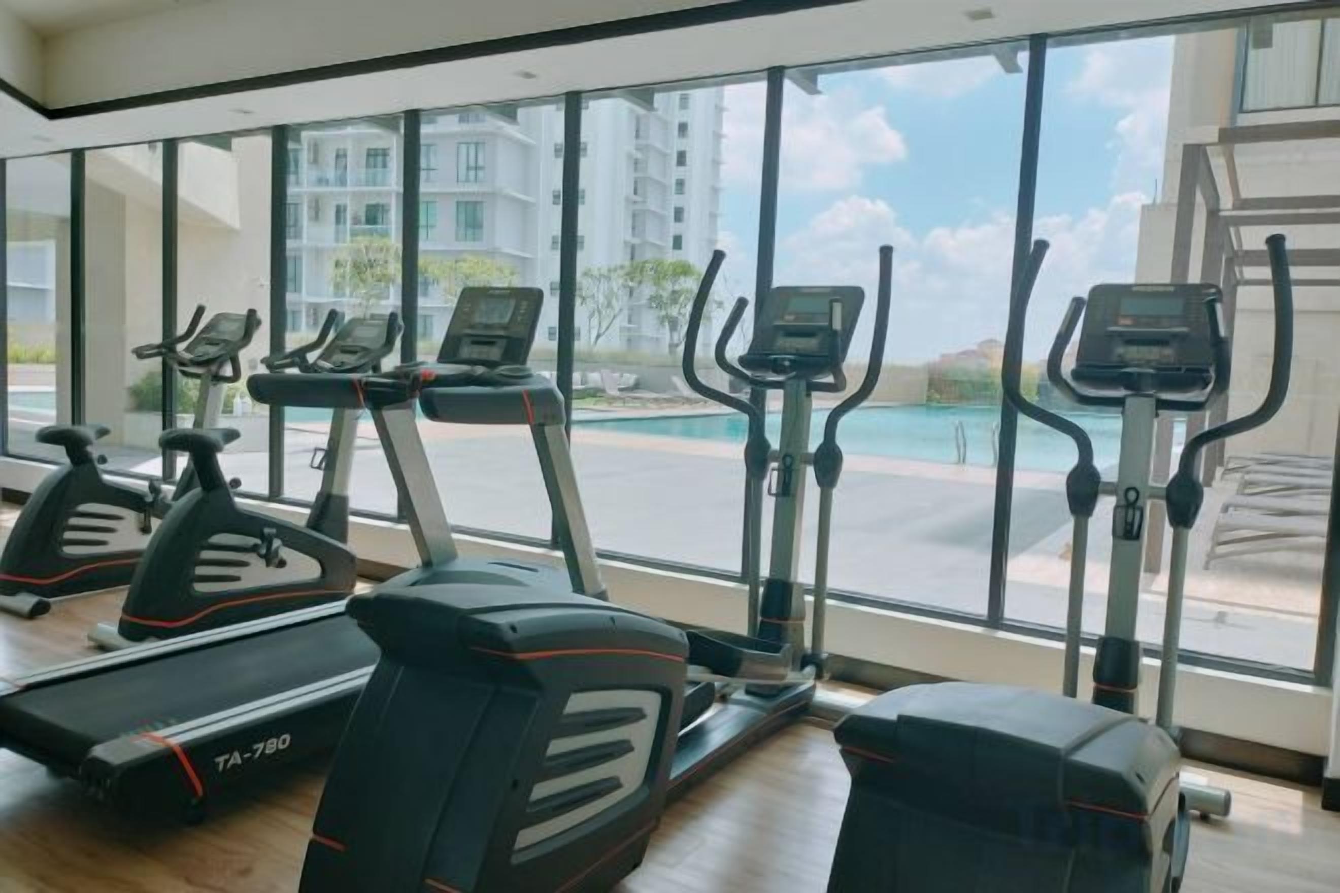 A gym with treadmills, elliptical machines, and a rowing machine.