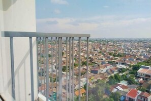 Un balcón con barandilla de metal que da a una zona residencial muy poblada.