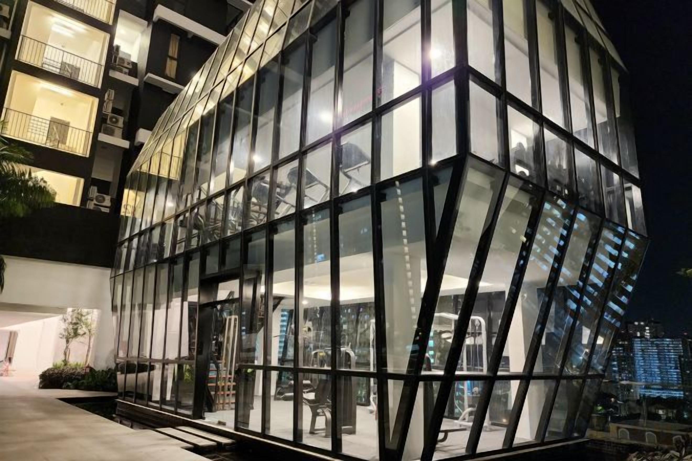 A modern building with a glass facade and a visible entrance.