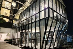 A modern building with a glass facade and a visible entrance. - Urban Muji Retreat Suites (George Town)