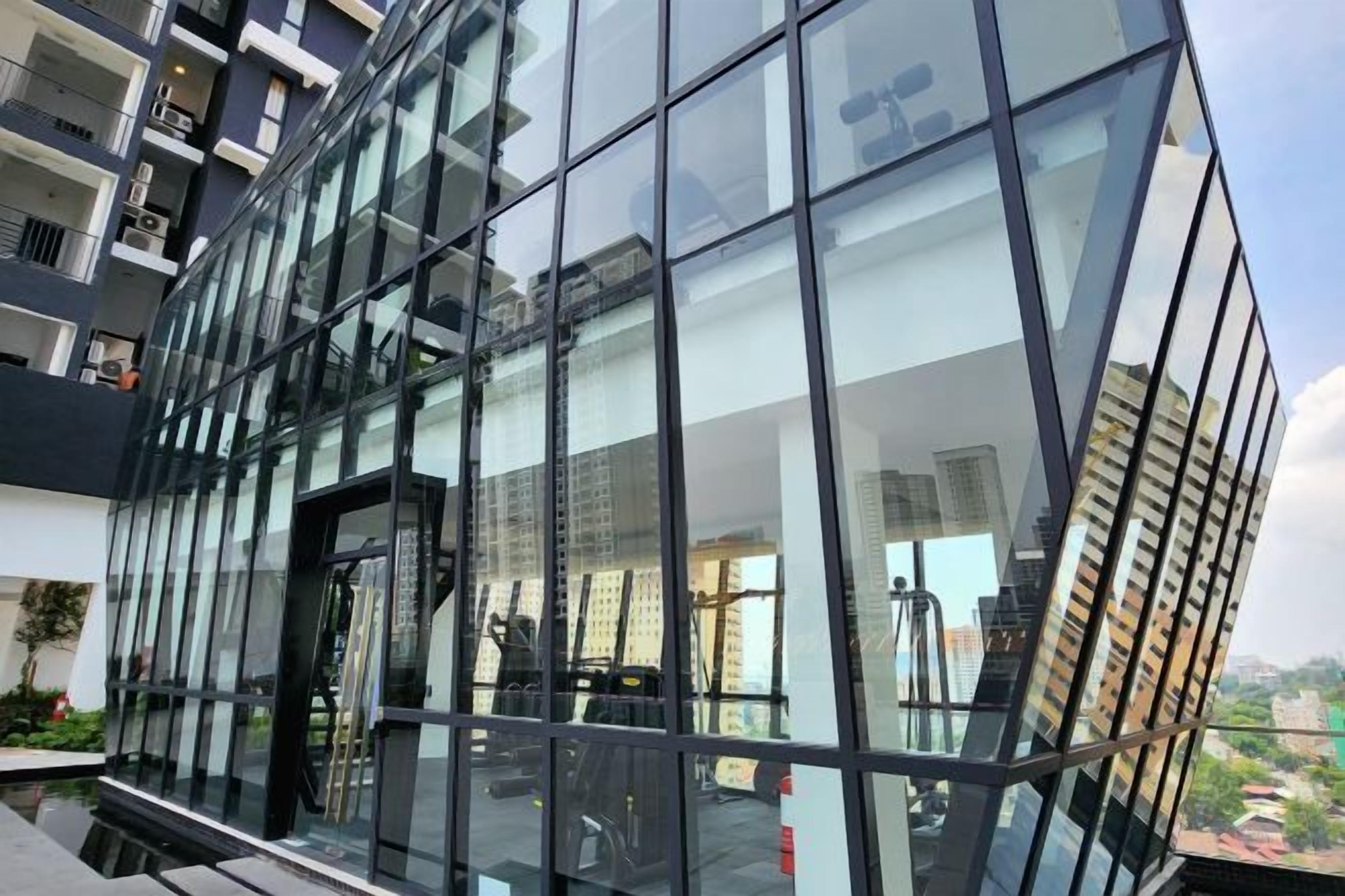 A modern building with large glass windows and a metal framework.