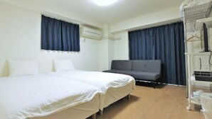 A hotel room with a bed, a sofa, an air conditioning unit, and a TV on a stand. - Guest houseNear Nijo CastleNear and quiet from the station A185 (Kyoto)