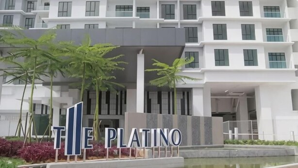A modern building with a sign reading 'MILE PLATINO' and a water feature in front. - PLATINO Kids Friendly, 3BR Family Suite, Next to Paradigm Mall Escape JB (Tebrau)