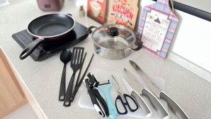 A kitchen counter with various utensils, a coffee maker, a kettle, and a coffee bag. - Georgetown Urban Suite Family Skypool I SeaView (Jelutong)