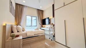 A modern bedroom with a bed, desk, and TV. - Nexus Kajang by Luvit Stay (Kajang)