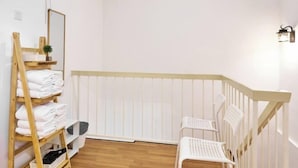 A small, clean room with a wooden ladder, white chairs, and a white radiator. - Ipoh South Homestay 8-16pax 10mins to attraction (Ipoh)