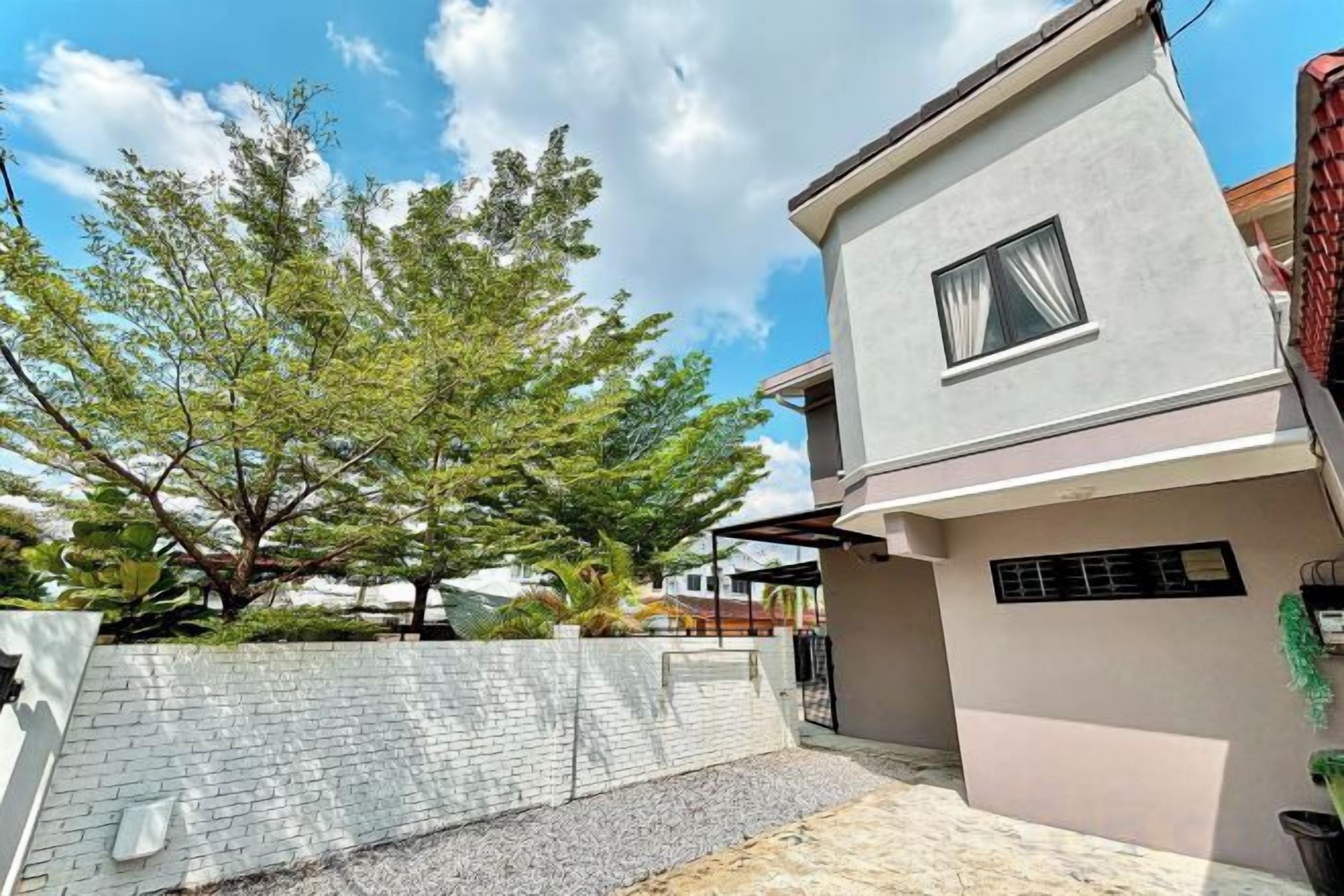 A modern house with a flat roof, a small window, and a paved driveway.