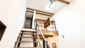 A staircase with wooden beams, a metal railing, and a ceiling light fixture. - 【Antiques Gifu Station East】Entire Villa for up to 10 Guests 10-Min Walk from JR Gifu Station (Gifu)