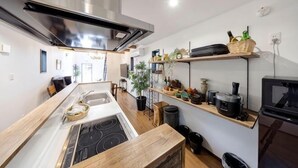 A modern kitchen with a central island, stainless steel range hood, and built-in appliances. - 【Antiques Gifu Station East】Entire Villa for up to 10 Guests 10-Min Walk from JR Gifu Station (Gifu)