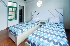 A room with two beds, a window, and a door. - Vj Sweethome Syariah Near GOR Turida (Turida)