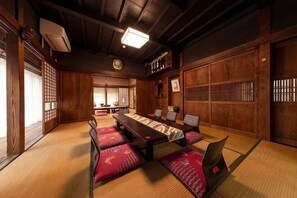 A traditional Japanese room with tatami mats, a low table, and sliding doors. - [Kao HOUSE Jakusui-an] 100-year-old traditional Japanese house stay (Katori)