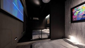 A modern hotel room with a large bed, a TV screen, and a colorful artwork on the wall. - Trive Ozone (Nagoya)