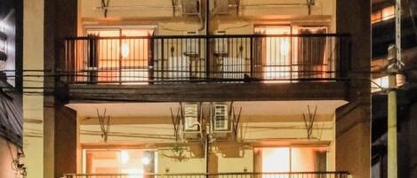 A multi-story building with balconies and air conditioning units.