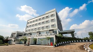 A multi-story hotel with a flat facade, large windows, and a covered entrance area. - Lakeside Tell Cikarang (Serang Baru)