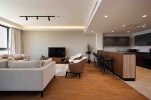 Economy Apartment, City View | Living area | 64-inch Smart TV with satellite channels - Aeon Towers Residence - BirdNest (6th of October City)