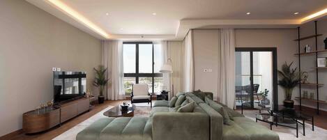 A modern living room with a large green sectional sofa, a flat-screen TV, and a minimalist decor.