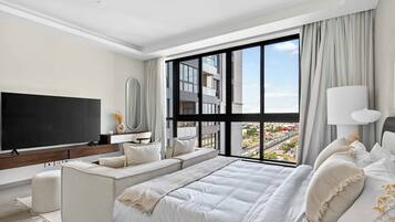 Luxury Suite | Living area | 64-inch Smart TV with satellite channels