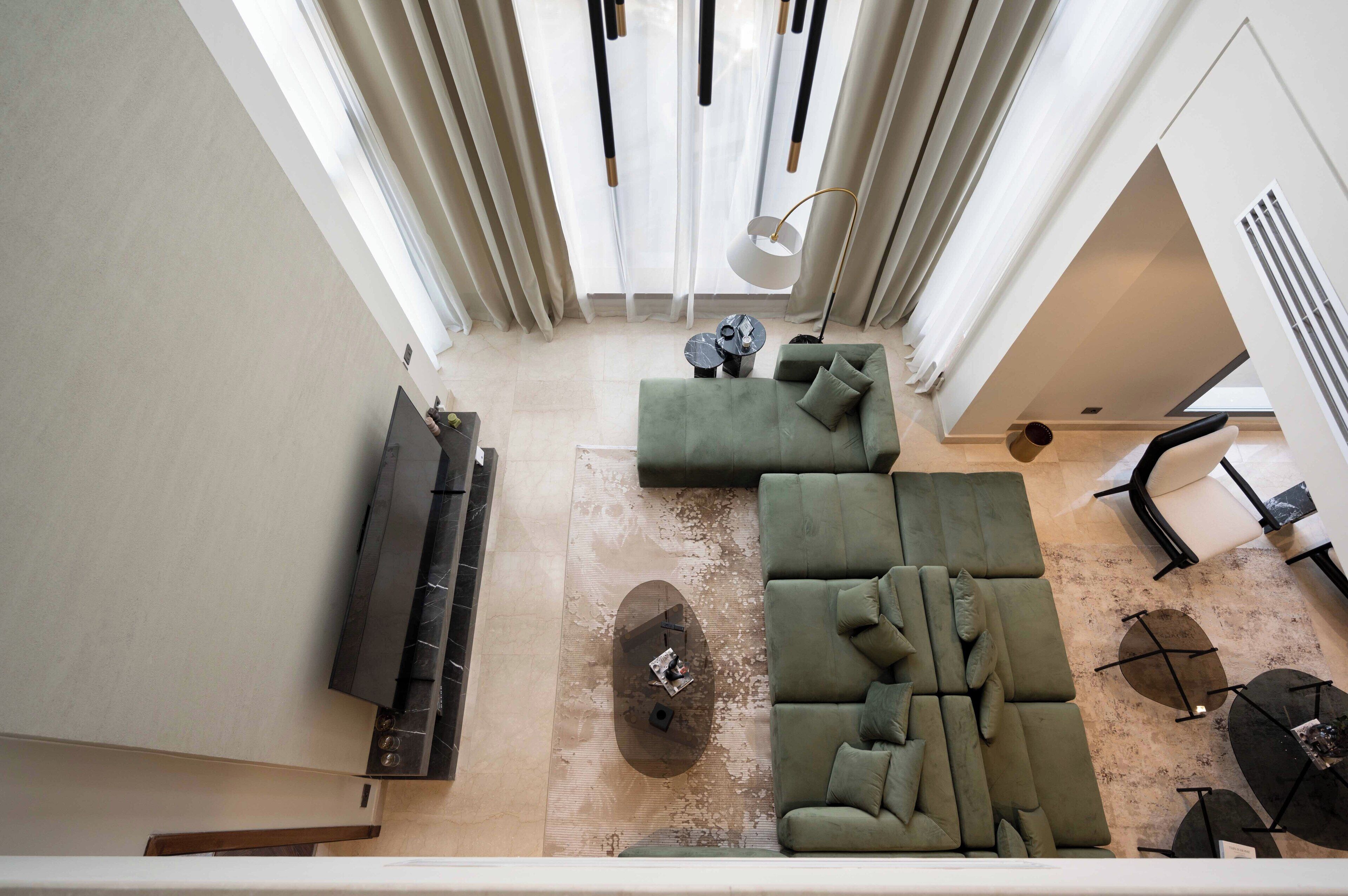 A modern living room with a sectional sofa, a flat-screen TV, and a coffee table.
