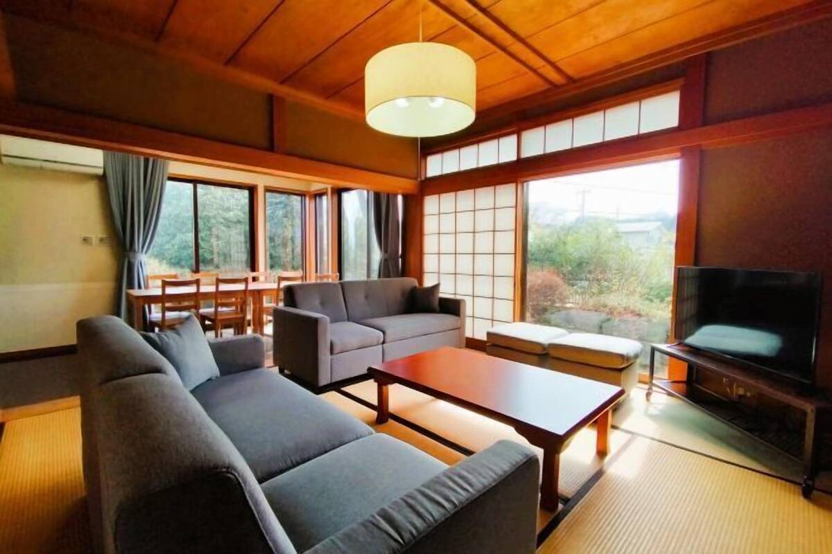 Un salon moderne avec un canapé, une table basse et un téléviseur.