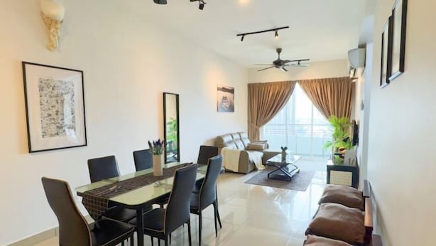 A modern living room with a glass dining table, black chairs, a sofa, a ceiling fan, and a large window with curtains. - D'Kayangan, Setia Ecohill Semenyih Serenity Suite (Semenyih)