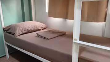 A bunk bed with a single bed on top and a lower bunk.