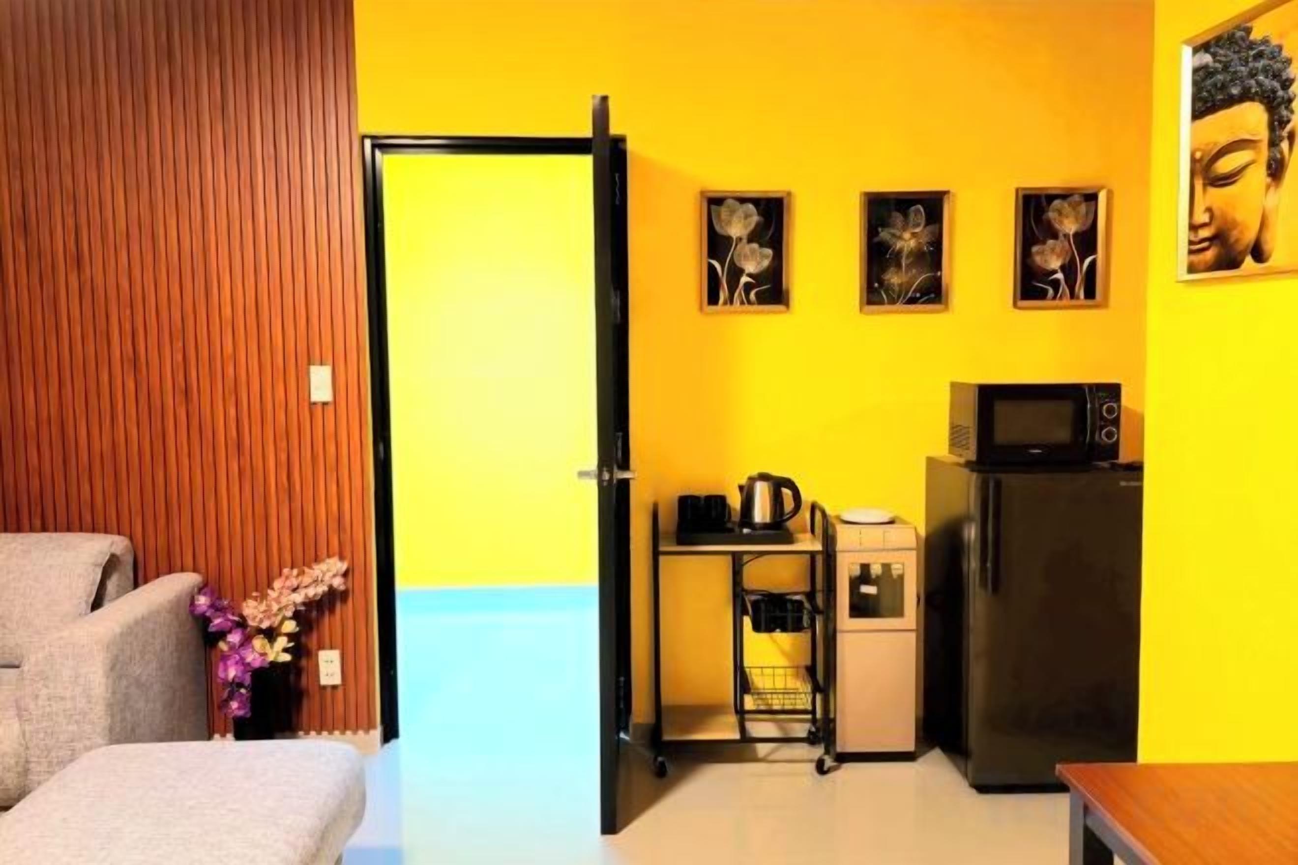 A compact living space with a kitchenette, a dining area, and a door leading to another room.